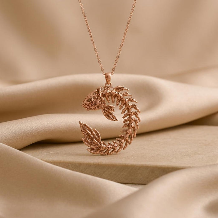 Rose Gold Plated Sacred Koi Relic pendant necklace with a curled openwork fish design on neutral satin