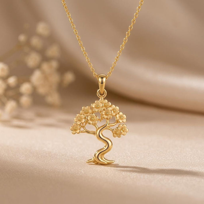 Gold Plated Silver Sakura Cloud Bonsai Necklace with clustered blossom canopy and double-curve trunk on neutral satin