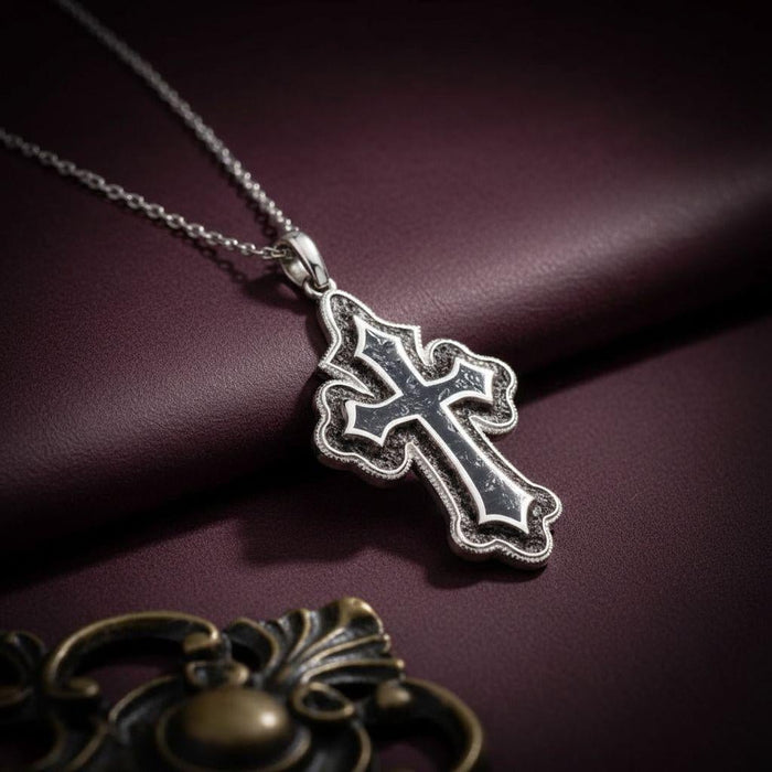 Close view of the dark-inlay cross pendant on burgundy leather