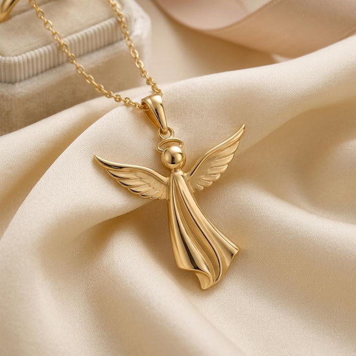 Gold Plated Silver sculpted angel pendant close-up with feathered wings and flowing robe