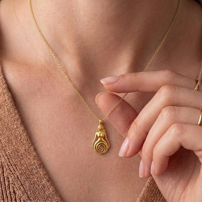 Close worn view of a Gold Plated Silver Spiral Goddess Necklace with fingers beside the open lower spiral pendant
