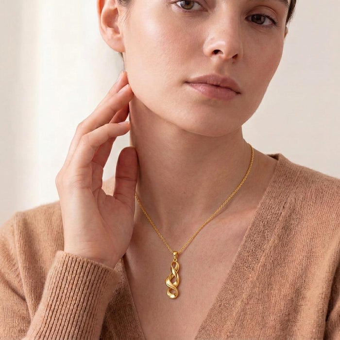 Model wearing a Gold Plated Silver Sculptural Ribbon Necklace with a vertical open-loop pendant