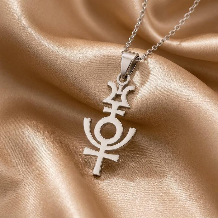 Close-up of the silver Serapis symbol pendant on champagne satin