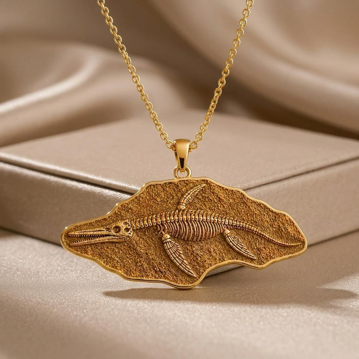 Gold Plated Silver Shonisaurus fossil pendant with skeleton relief on champagne satin