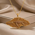 Gold Plated Silver Shonisaurus fossil pendant with skeleton relief on champagne satin