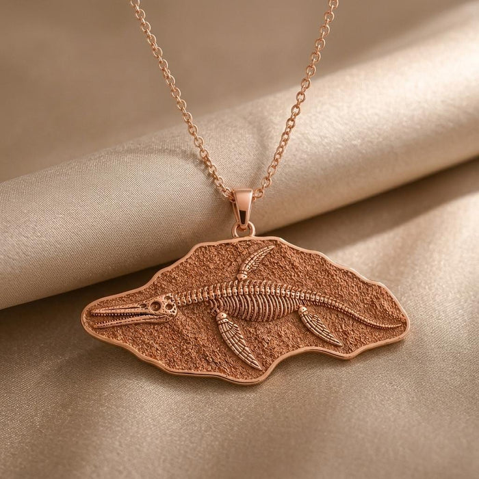 Rose Gold Plated Shonisaurus fossil pendant with textured skeleton relief