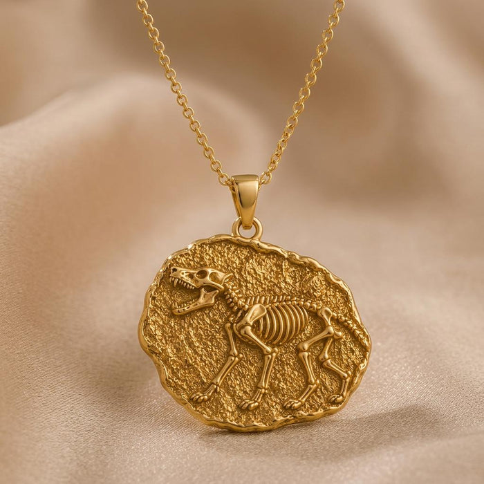Gold Plated Silver Dire Wolf Fossil Pendant Necklace with raised skeleton relief on a textured irregular disc