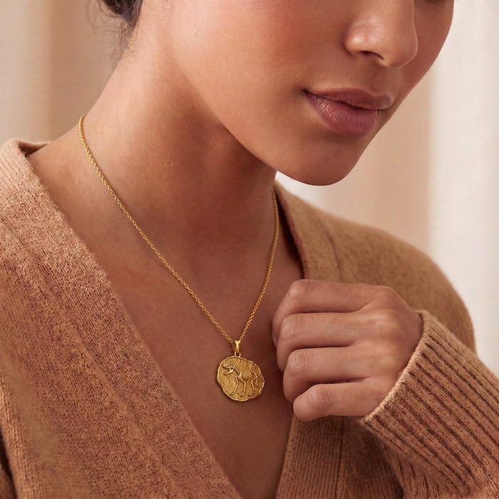 Gold Plated Silver Dire Wolf Fossil Pendant Necklace worn at the neckline with a knit top