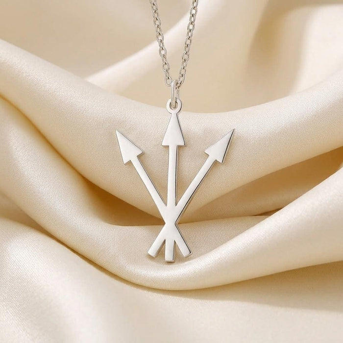 Close-up of the Silver Alchemy Symbol Necklace triple-arrow pendant on ivory satin