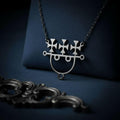 Sitri Seal Sigil Necklace displayed on dark navy textured fabric with a foreground jewelry-like prop