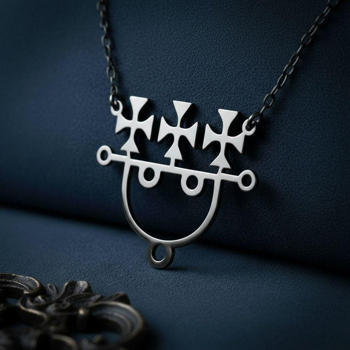 Sitri Seal Sigil Necklace on dark navy textured fabric with three cross-like upper forms, an open circular lower frame, and a foreground jewelry-like prop