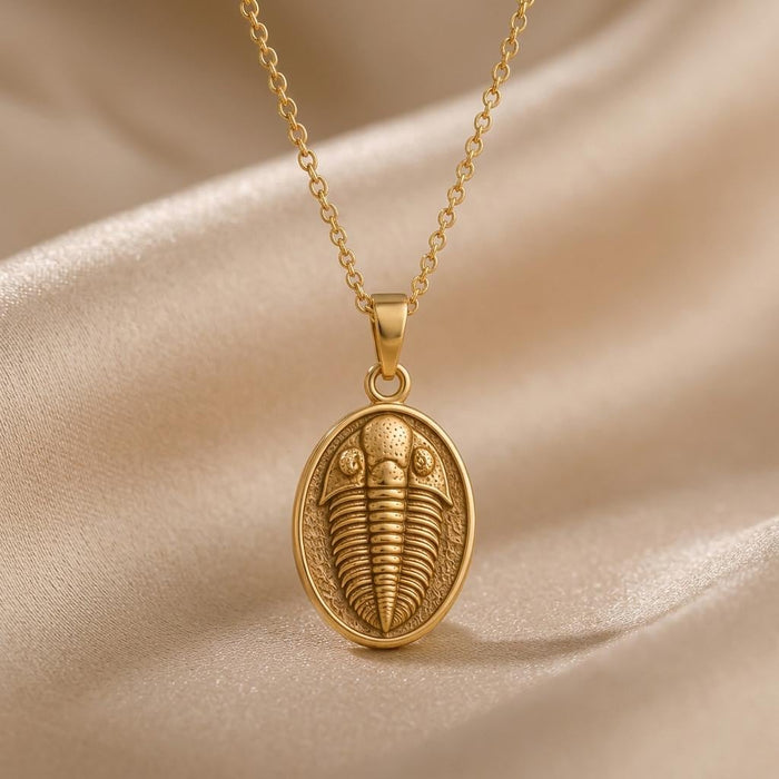Gold Plated Silver trilobite fossil pendant necklace on champagne satin