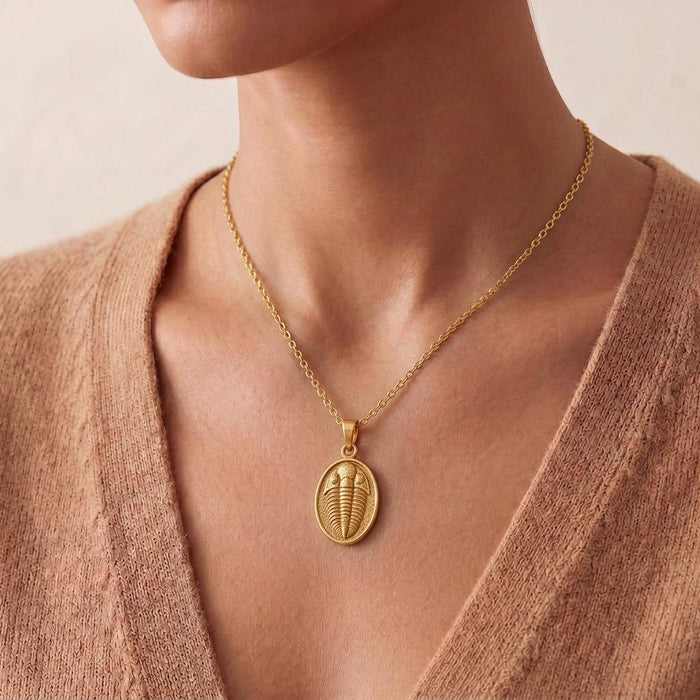 Gold Plated Silver trilobite pendant necklace worn at the collarbone