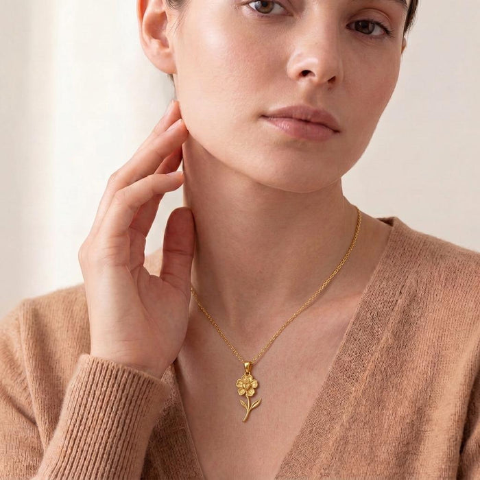 Model wearing a Gold Plated Silver Snapdragon Flower Necklace with a vertical layered flower pendant over a neutral knit top