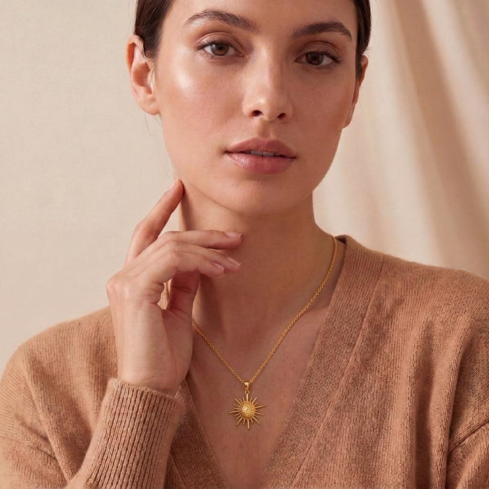 Model wearing the Solar Fragment Necklace in Gold Plated Silver with a textured sunburst pendant