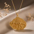 Gold Plated Silver Spinosaurus Fossil Pendant Necklace on champagne satin with dried flowers