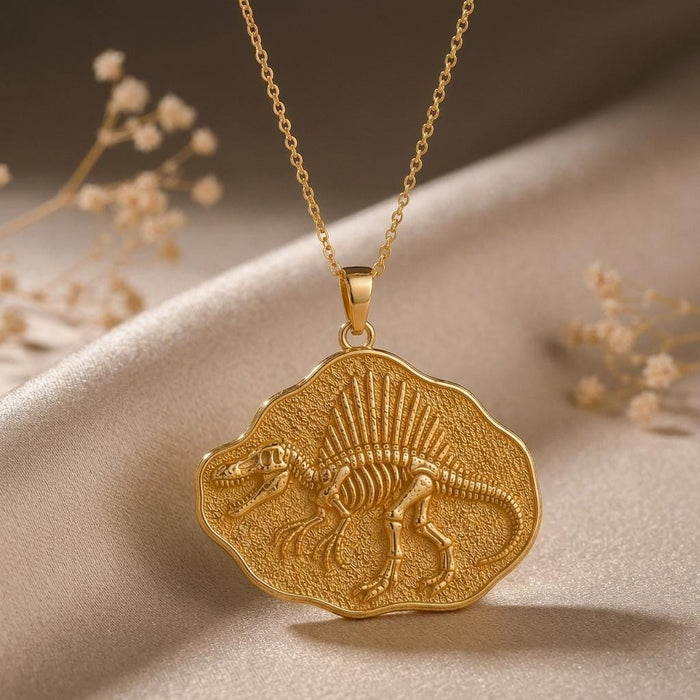 Gold Plated Silver Spinosaurus Fossil Pendant Necklace on champagne satin with dried flowers