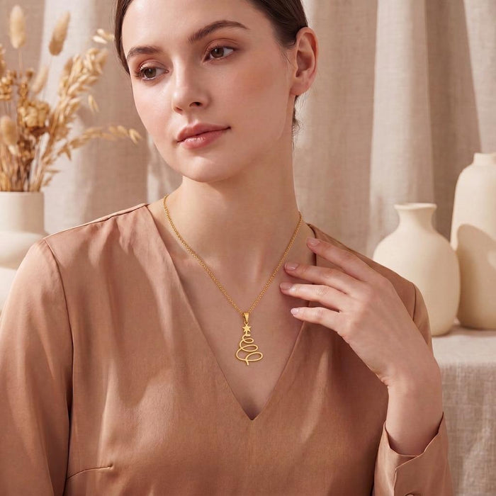 Gold Plated Silver spiral Christmas tree necklace worn with a satin V-neck blouse