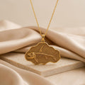 Gold Plated Silver Stethacanthus fossil pendant necklace with raised fish skeleton on a scalloped plaque over beige satin