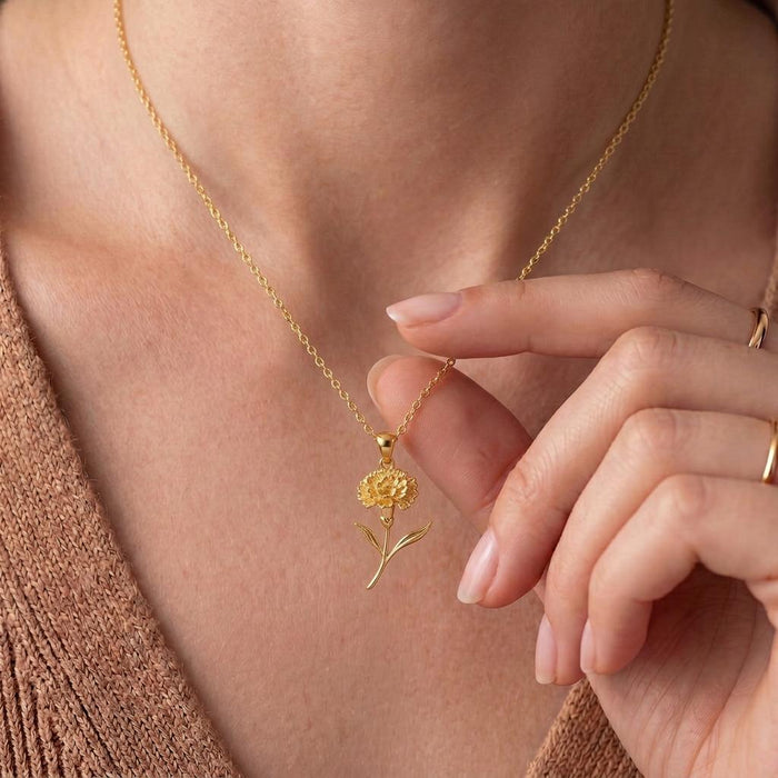 Gold Plated Silver Stock Flower Pendant Necklace worn at the neckline beside a hand