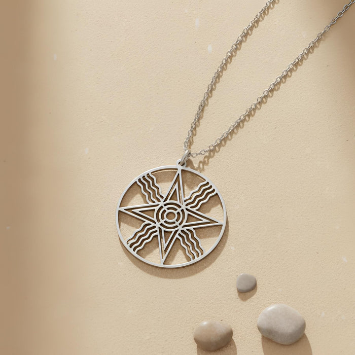Silver Sumerian Sun Pendant Necklace flat lay with round openwork star medallion