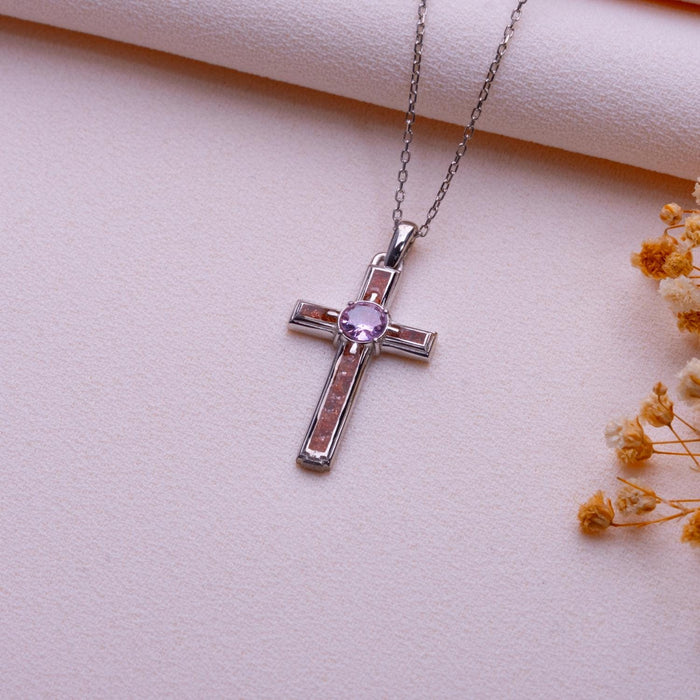 Full view of the framed Sunstone Cross Necklace with warm-toned inlay panels and center stone