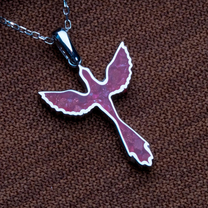 Angled close-up of the sunstone jasper dove pendant with scalloped wings