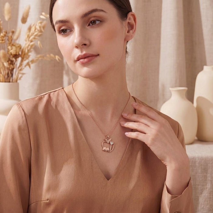 Rose Gold Plated Teacher Apple Necklace worn with a peach V-neck blouse