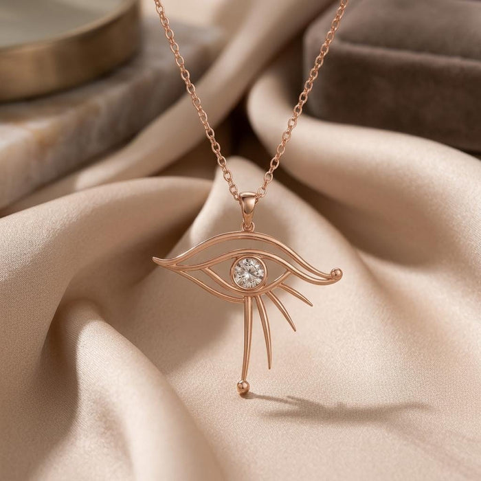 Rose Gold Plated Celestial Eye Pendant with a round center detail and three lower rays on draped satin