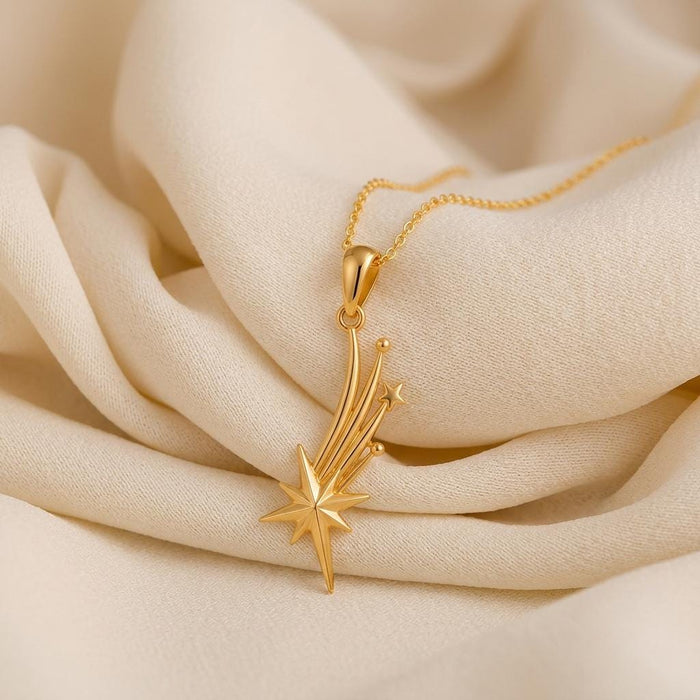 Gold Plated Silver Falling Star Pendant Necklace on folded ivory fabric
