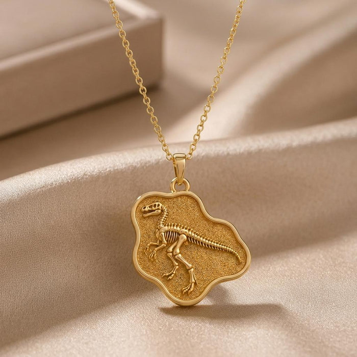 Gold Plated Silver Troodon Fossil Pendant Necklace with raised skeleton relief on textured satin