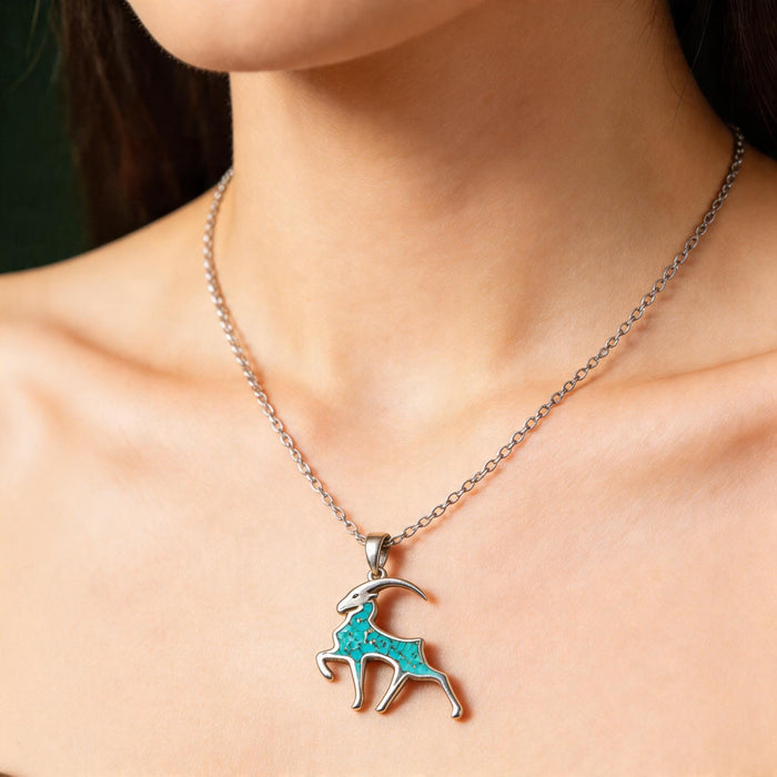 Silver Turquoise Capricorn Goat Necklace worn at the collarbone