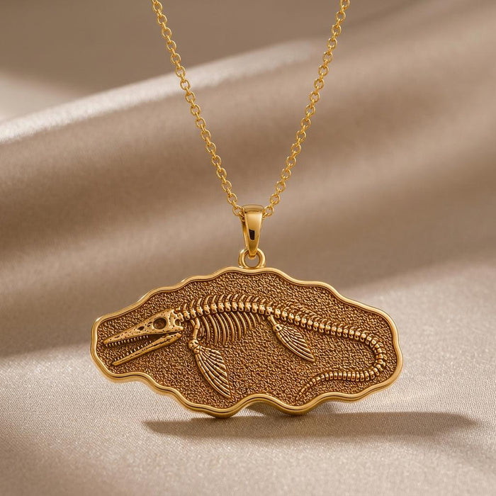 Gold Plated Silver Tylosaurus fossil pendant necklace with skeleton relief on champagne satin