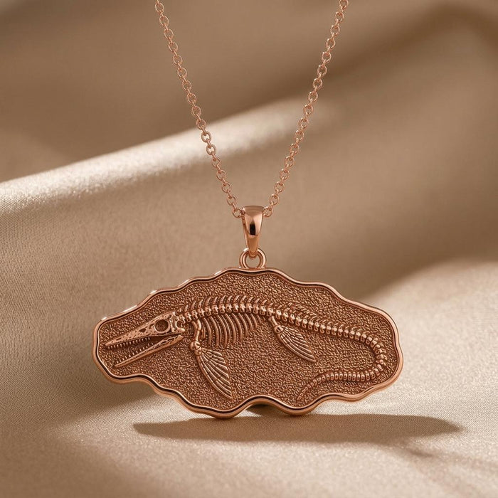 Rose Gold Plated Tylosaurus fossil pendant necklace close-up on champagne satin