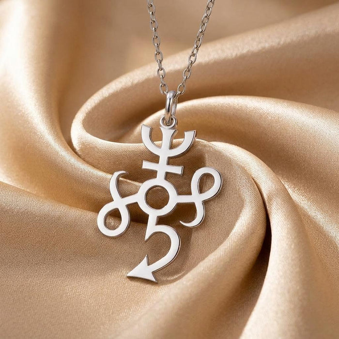 Close-up of the polished Typhon symbol pendant on champagne satin