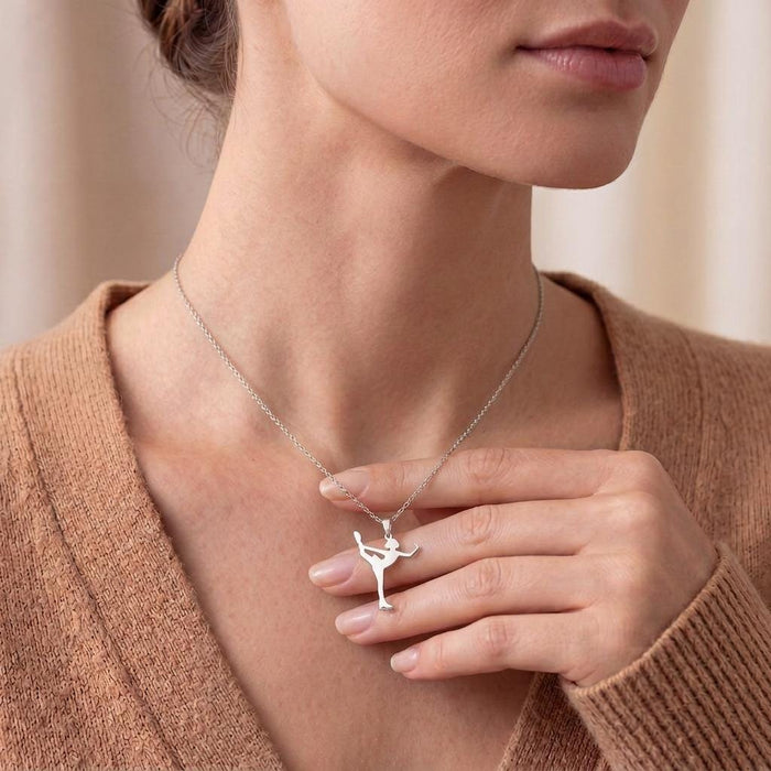 Model holding the Figure Skater pendant to show its upright skating silhouette