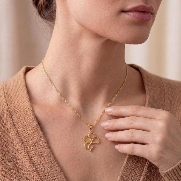 Close view of a model wearing the four-petal Velvet Petal Pendant Necklace