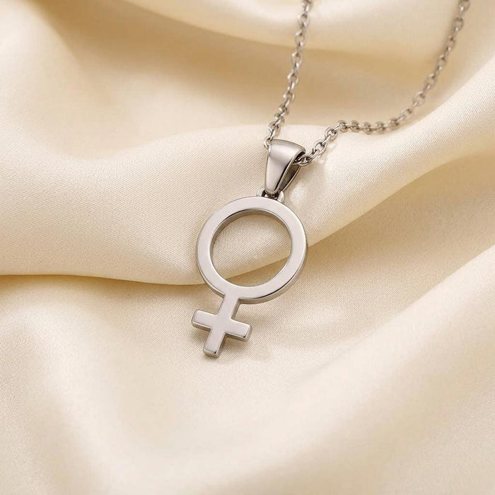 Close view of the polished Venus symbol pendant on cream satin