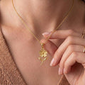 Gold Plated Silver Verbena Flower Pendant Necklace worn at the neckline, showing the multi-petal flower, curved stem, and two leaves