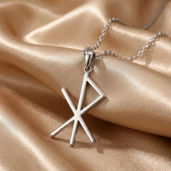 Close-up of the Silver Viking Love Bind Rune pendant with its open triangular upper section on champagne satin