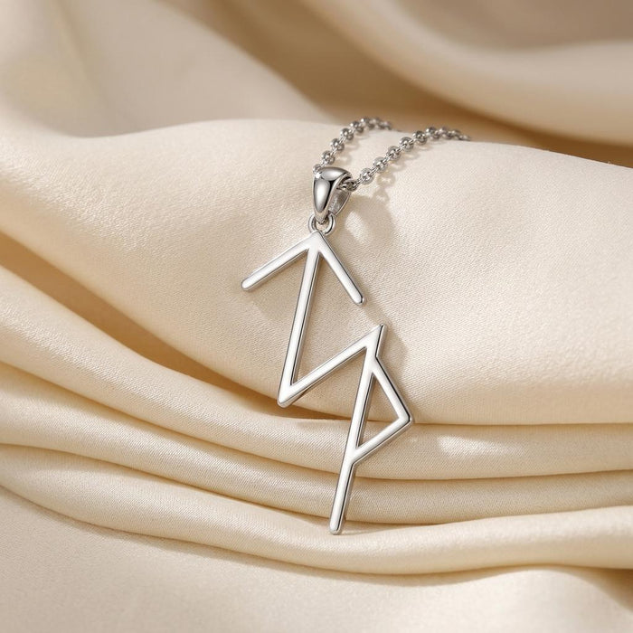 Silver Viking Success rune pendant necklace displayed on cream satin