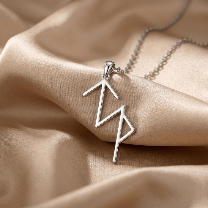 Close-up of a Silver Viking Success rune pendant on champagne satin