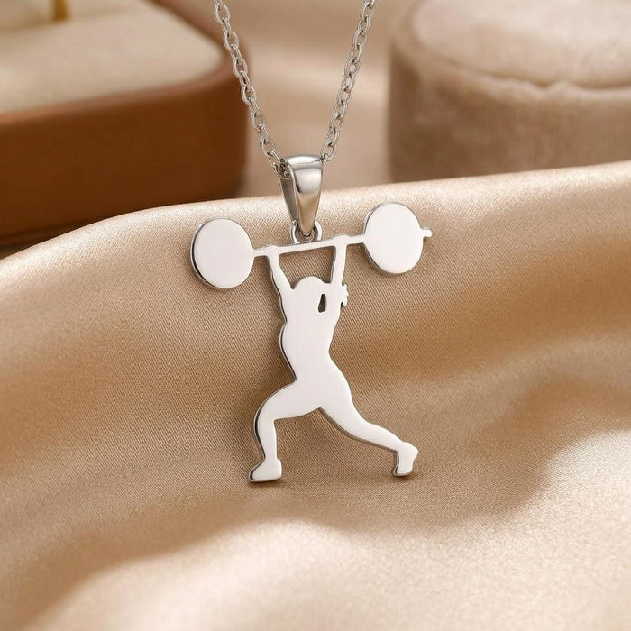 Close-up of a polished weightlifting athlete pendant with round barbell weight plates