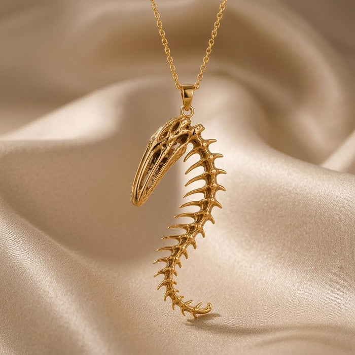 Front view of a Gold Plated Silver Whale Spine Relic pendant showing its openwork whale skull and curved vertebrae