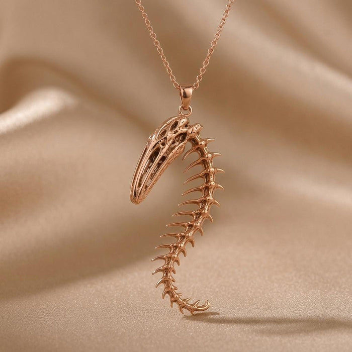 Close view of a Rose Gold Plated Whale Spine Relic pendant with pointed vertebrae projections and a curled tail tip