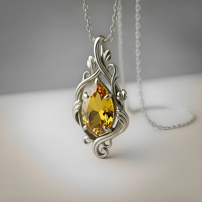 Silver Yellow Topaz Teardrop Necklace with a faceted yellow teardrop stone in an ornate openwork scrollwork frame