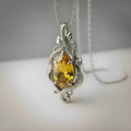 Silver Yellow Topaz Teardrop Necklace with a faceted yellow teardrop stone in an ornate openwork scrollwork frame