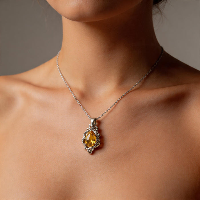Silver Yellow Topaz Teardrop Necklace worn at the collarbone with a faceted yellow teardrop center stone